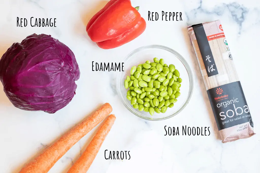 red cabbage, carrots, edamame, red pepper, soba noodles, on counter.