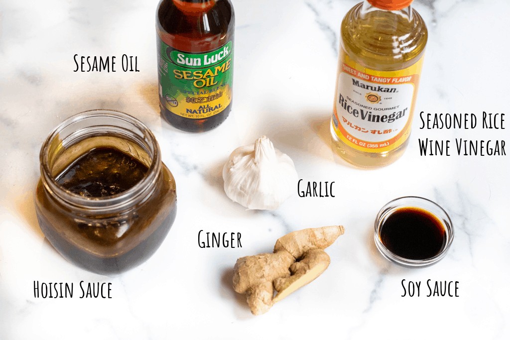 hoisin, sesame oil, vinegar, garlic, ginger, and soy on counter.