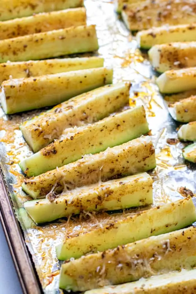 baked zucchini spears on aluminon foil.