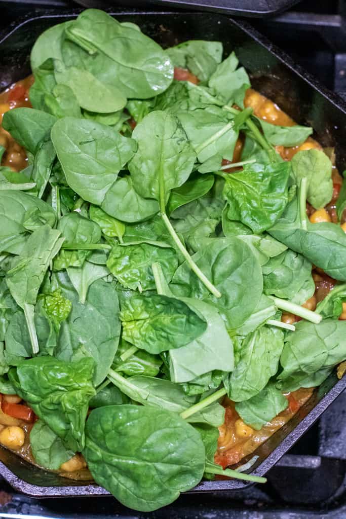 fresh spinach in a cast iron.