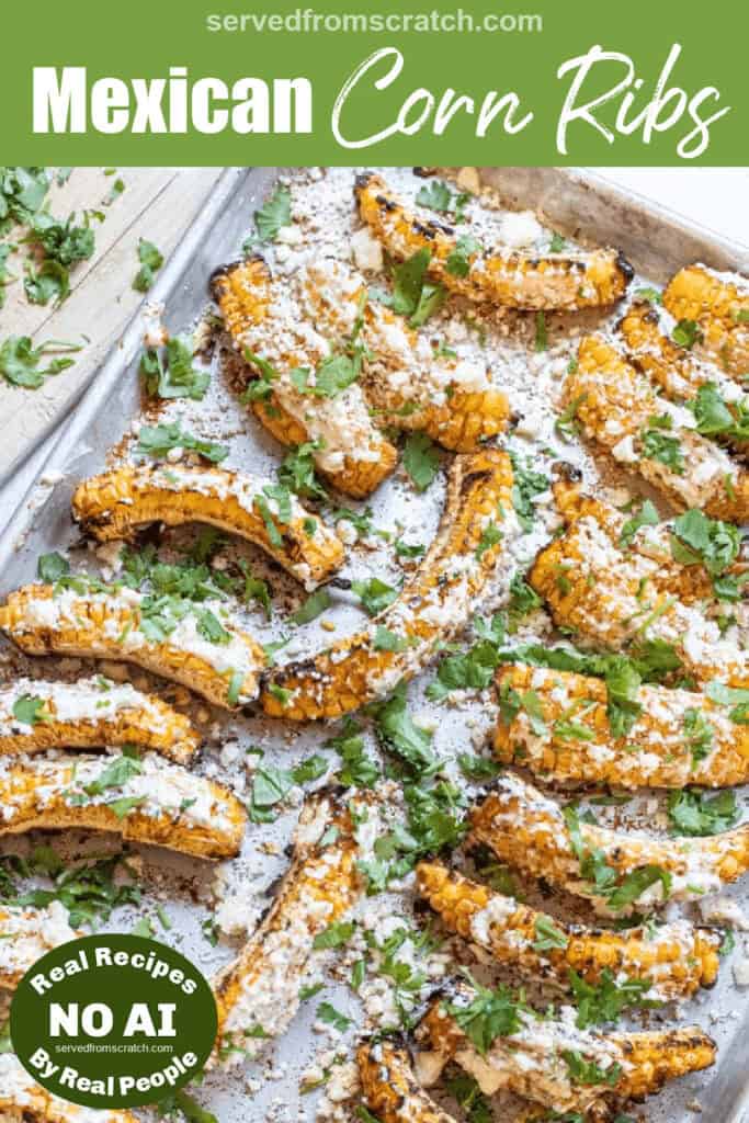 an overhead of a tray of corn ribs grilled and covered in cheese with Pinterest pin text and NO AI sticker.