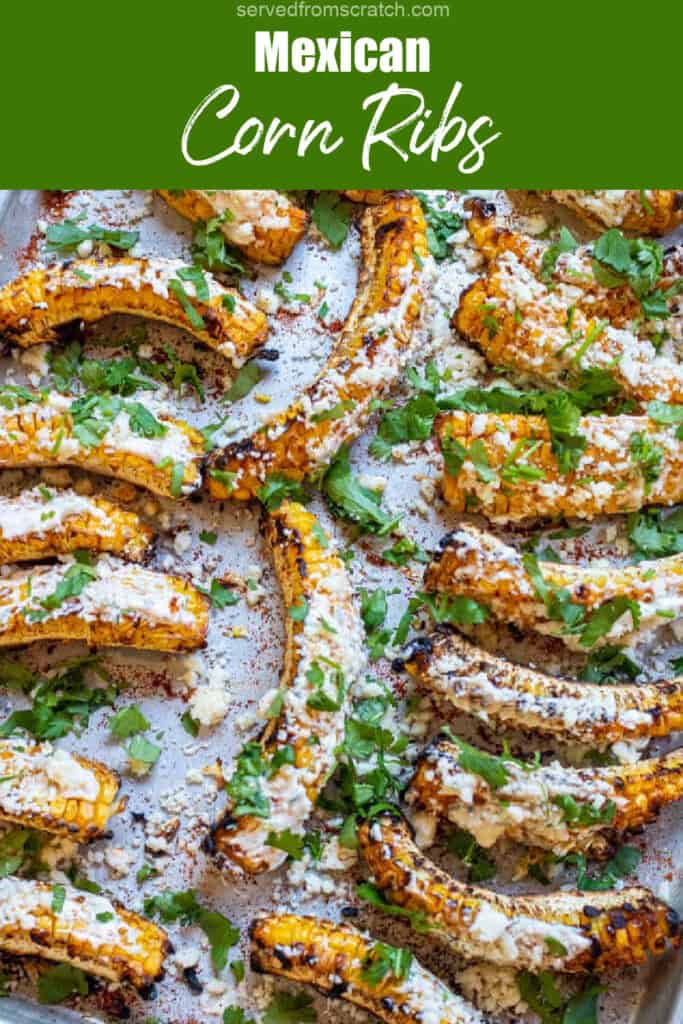 an overhead of a tray of corn ribs grilled and covered in cheese with Pinterest pin text.