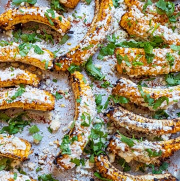 cooked Mexican corn ribs, coated with cheese and cilantro.