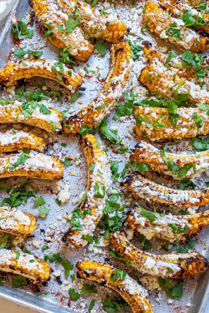 cooked Mexican corn ribs, coated with cheese and cilantro.