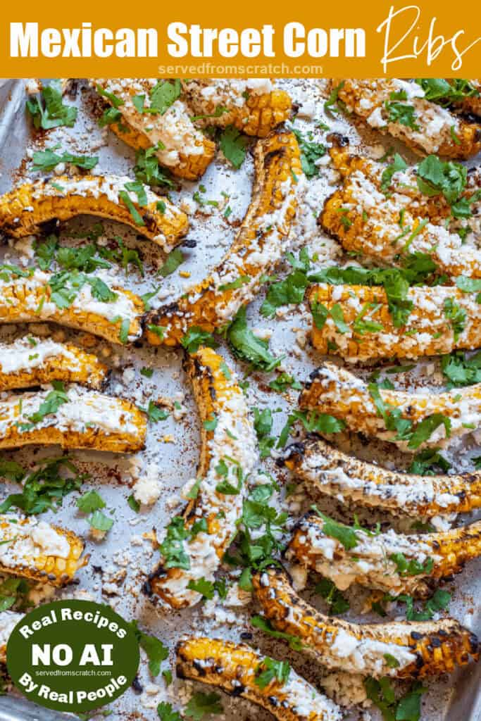 an overhead of a tray of corn ribs grilled and covered in cheese with Pinterest pin text and NO AI sticker.