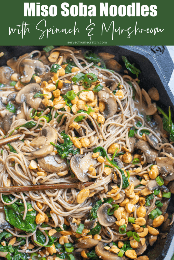 cast iron of noodles with spinach, mushrooms, topped with peanuts and scallions with Pinterest pin text.