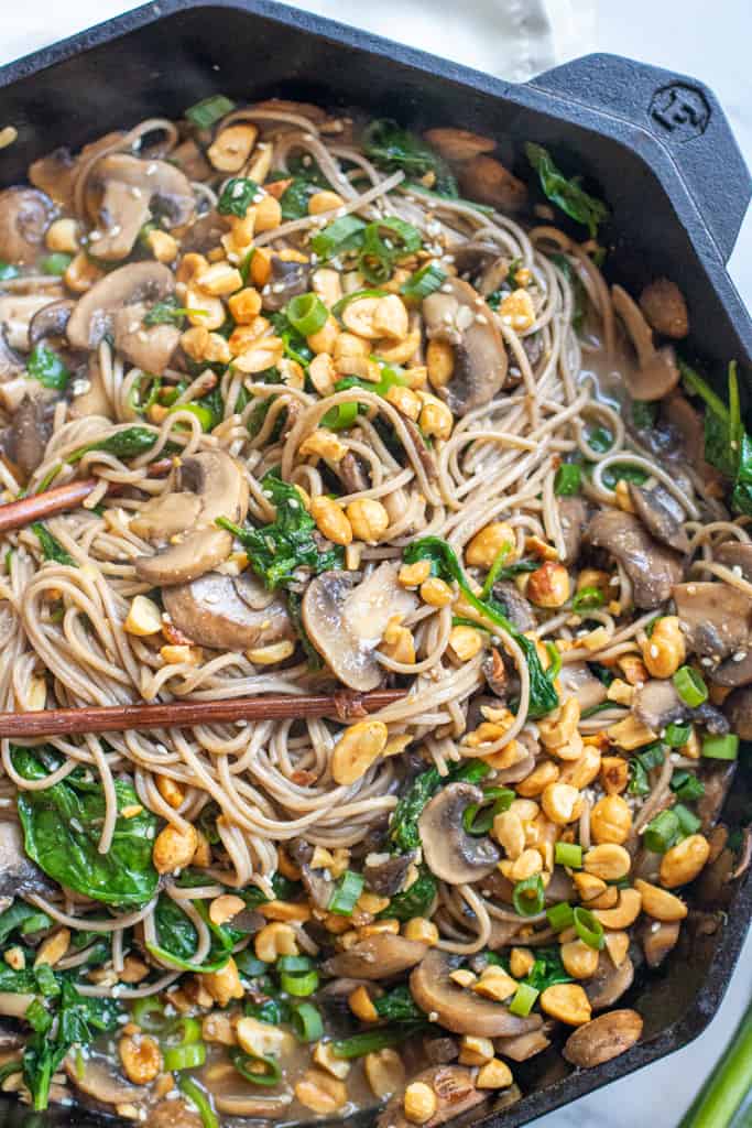 cast iron of noodles with spinach, mushrooms, topped with peanuts and scallions.