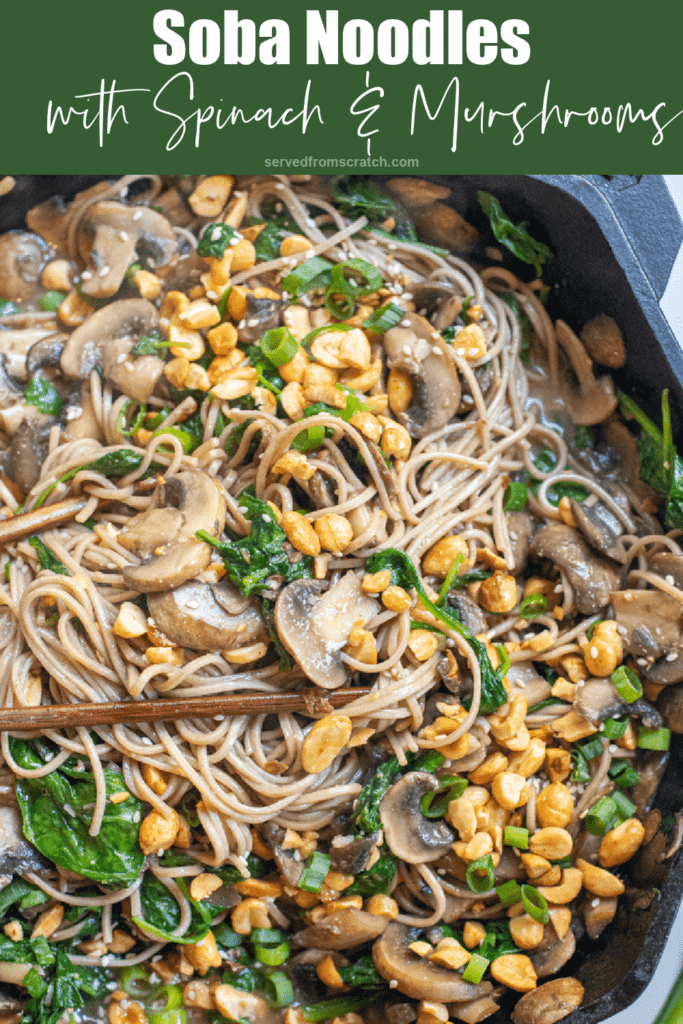 cast iron of noodles with spinach, mushrooms, topped with peanuts and scallions with Pinterest pin text.
