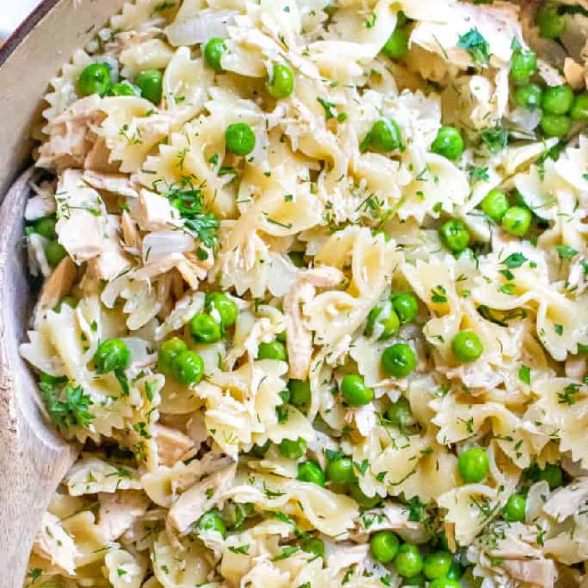 a large pot with farfalle pasta, peas, and tuna.