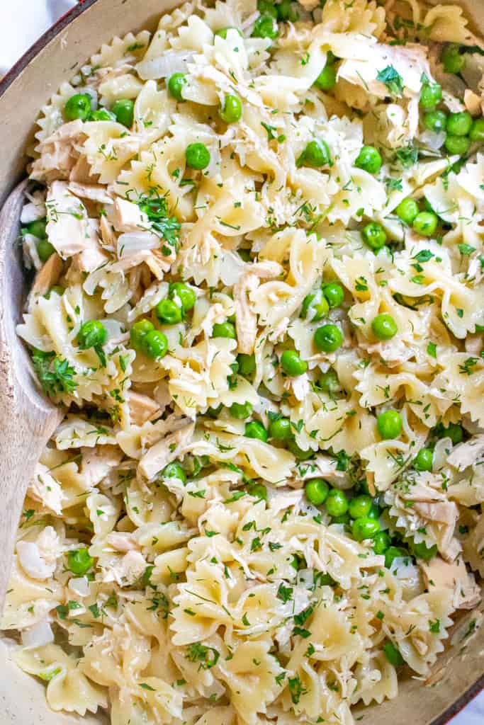 a large pot with farfalle pasta, peas, and tuna.