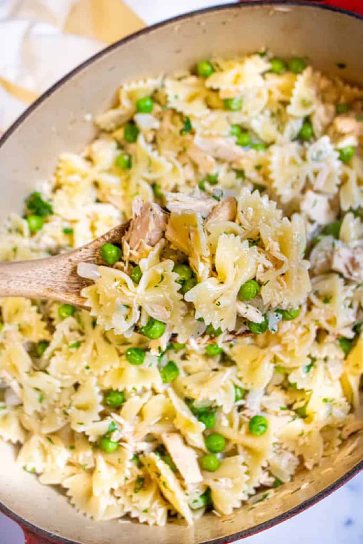 a large pot with farfalle pasta, peas, and tuna.