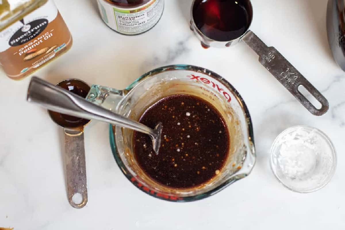 sauce ingredients and sauce in a pyrek on counter.