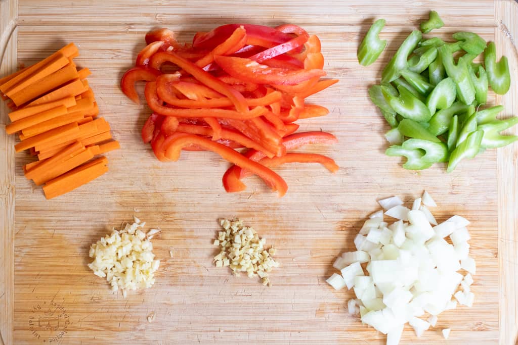 sliced and diced veggies on a cutting board.