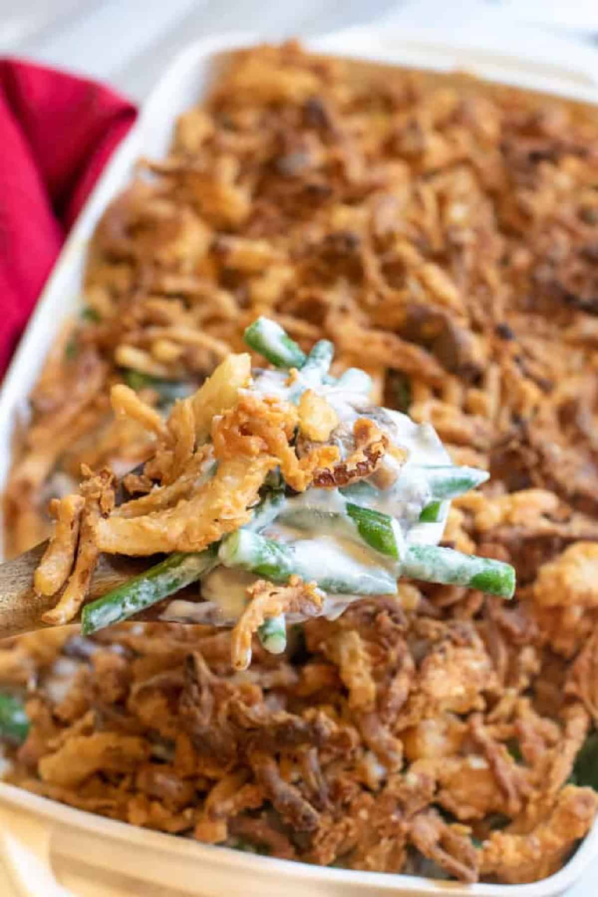 green bean casserole with a spoon scooping some out.