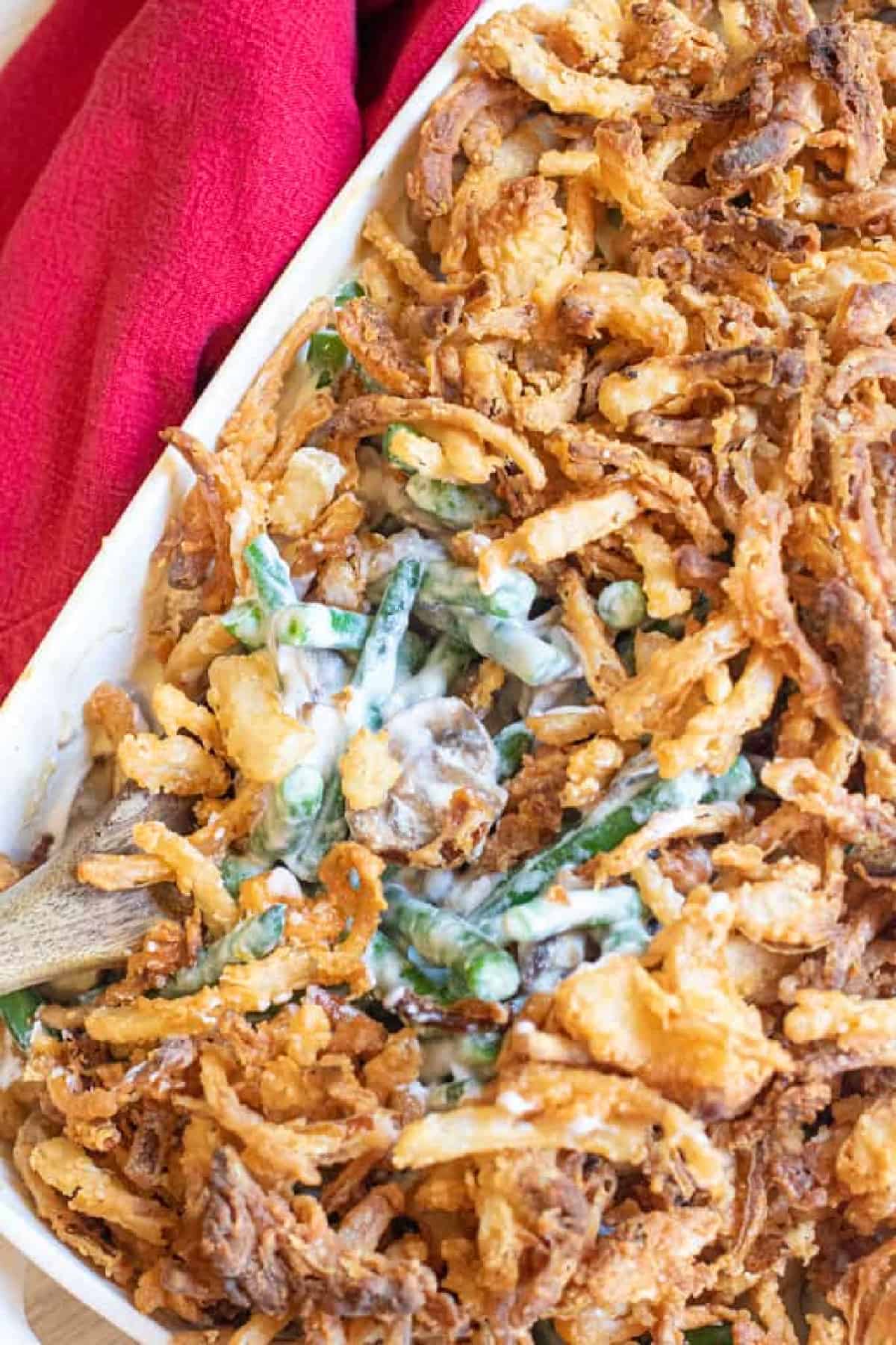 green bean casserole with a spoon scooping some out.