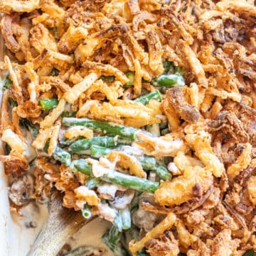 green bean casserole with a spoon scooping some out.