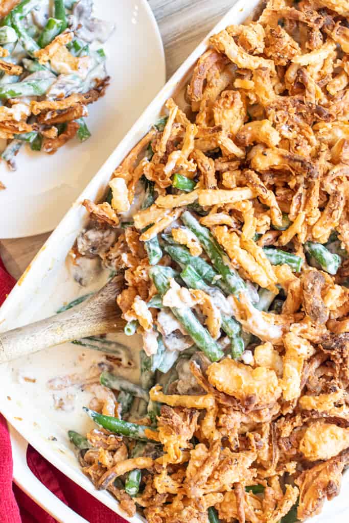 green bean casserole with a spoon scooping some out.