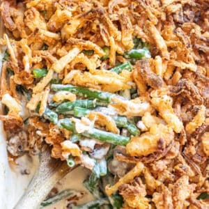 green bean casserole with a spoon scooping some out.