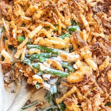 green bean casserole with a spoon scooping some out.