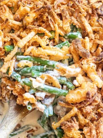 green bean casserole with a spoon scooping some out.