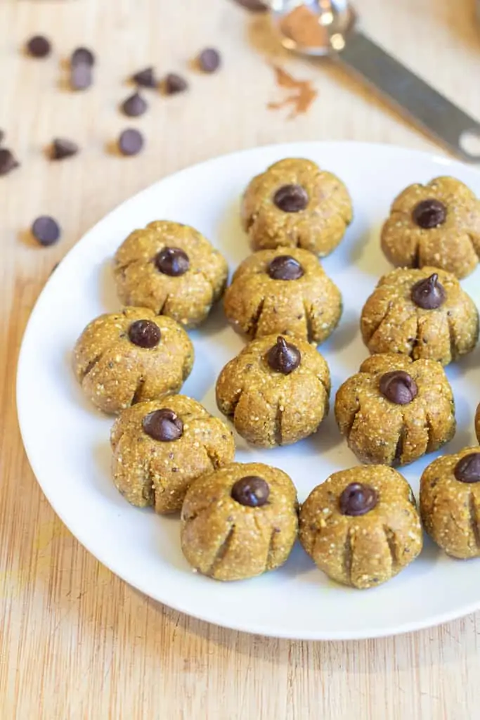 a plate of little pumpkin shaped energy balls.