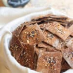 a bowl of crispy crackers with everything bagel toppings.