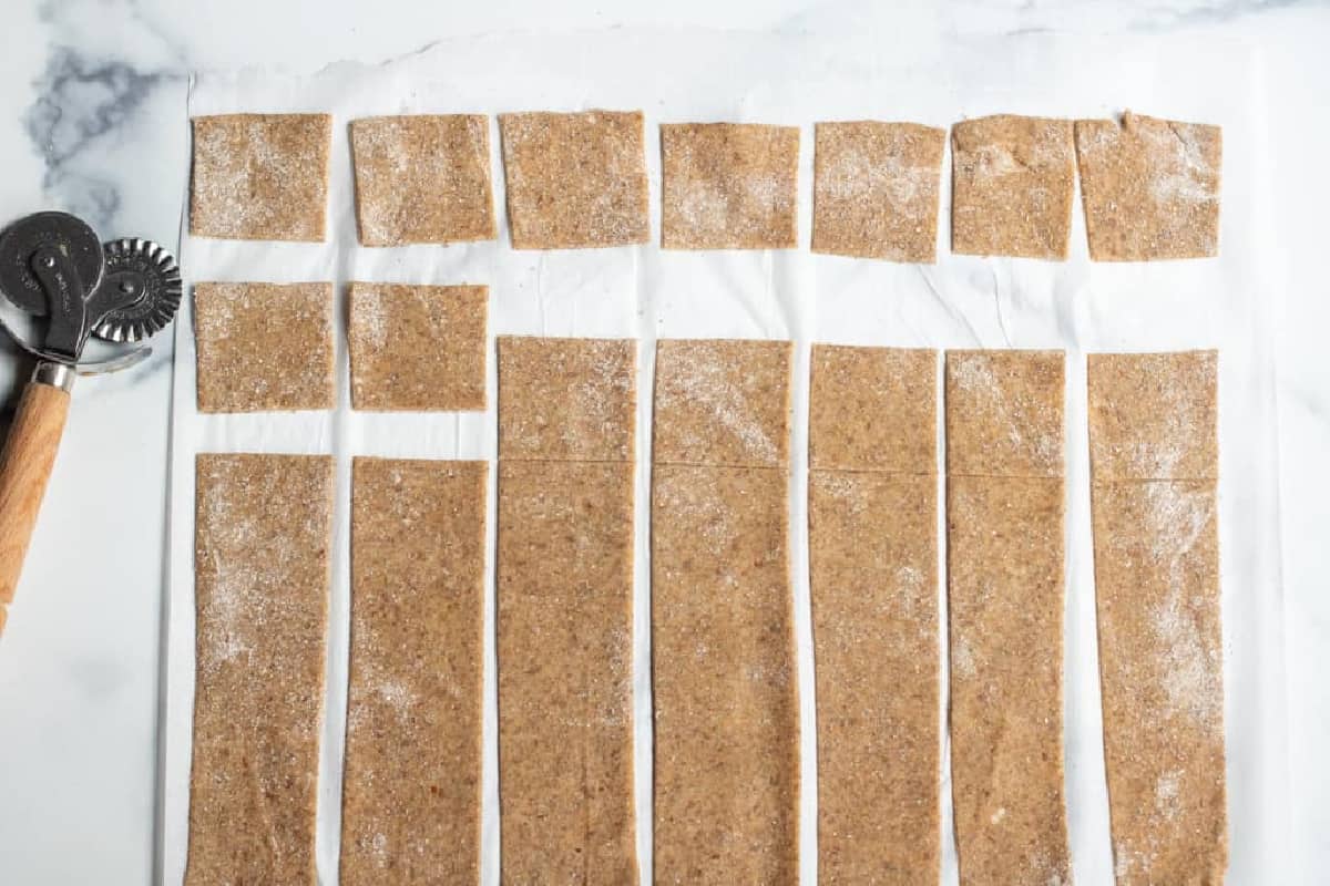pastry cutter and squares cut out of dough.