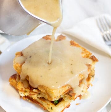 gravy being poured on waffles.