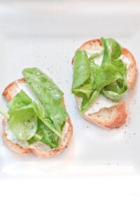 a place with arugula topped crostini.