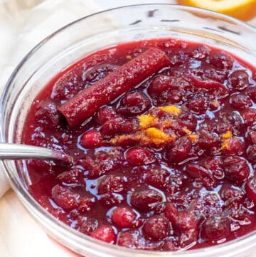 a bowl of homemade cranberry sauce with a spoon.