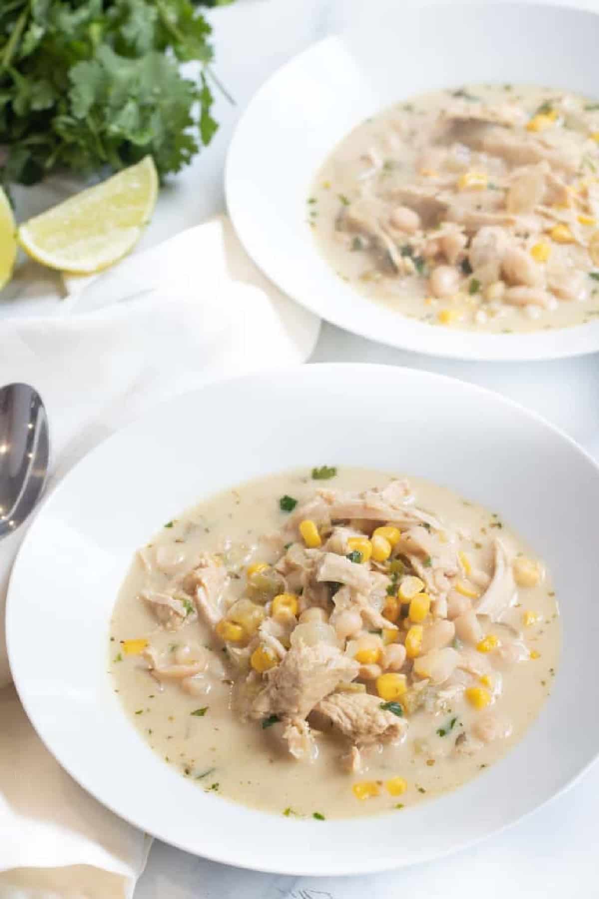 a spoonful of white chili over a bowl.