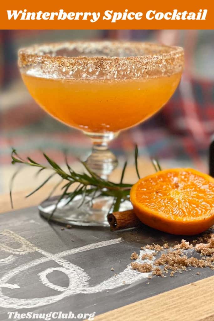 a sugar rimmed glass with an orange cocktail with Pinterest pin text.