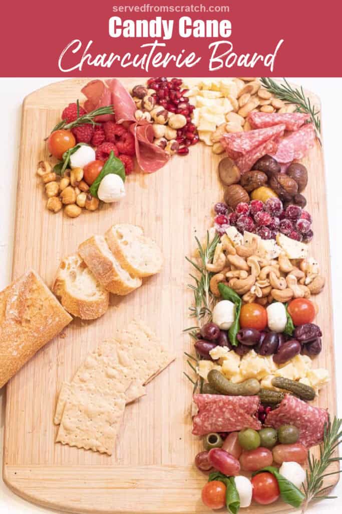 candy cane shaped charcuterie board with Pinterest pin text.