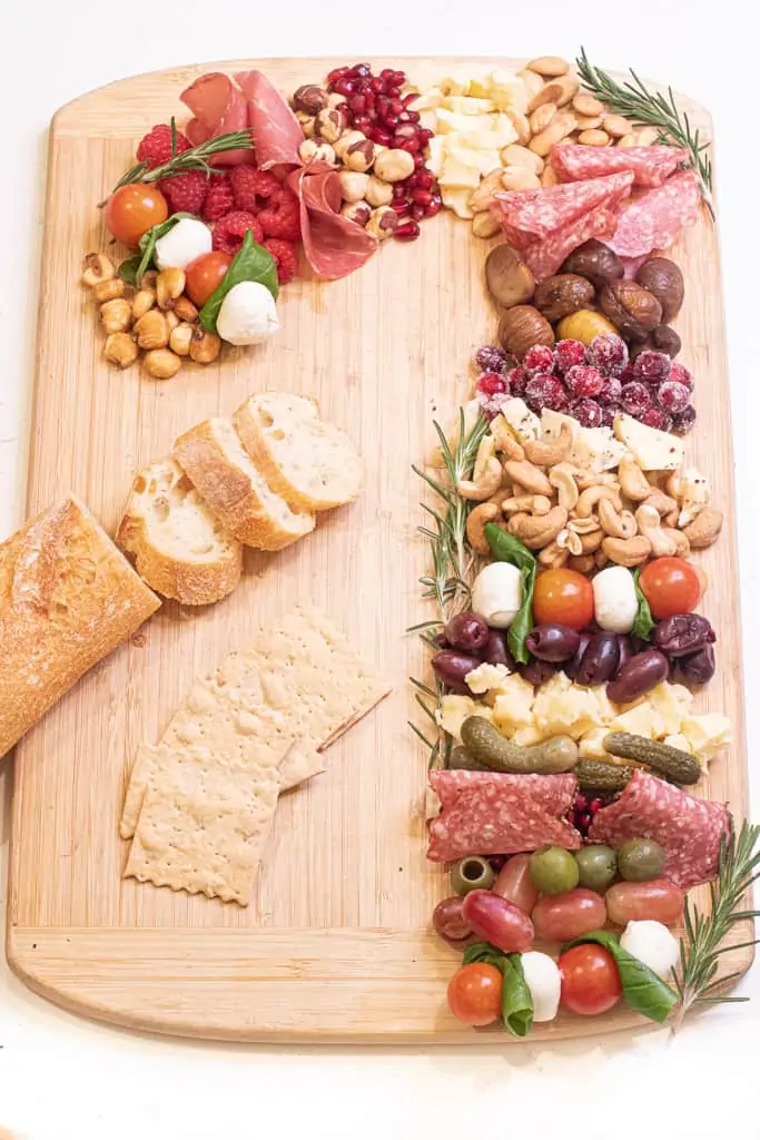 a Charcuterie Board in the shape of a candy cane on a cutting board.