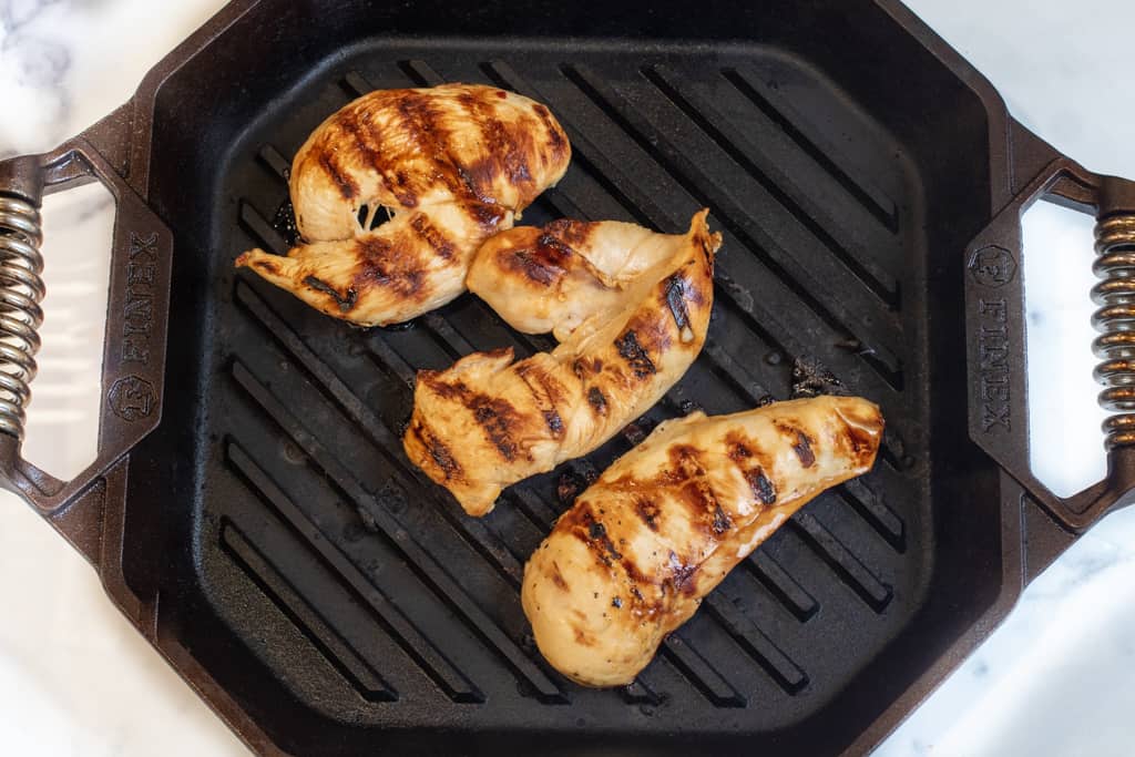 grilled chicken breasts on a grill pan.