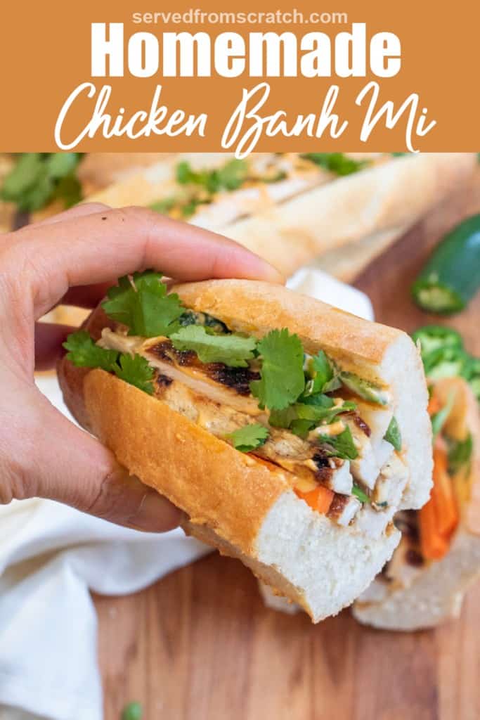 a hand holding a half of a banh mi sandwich with Pinterest pin text.