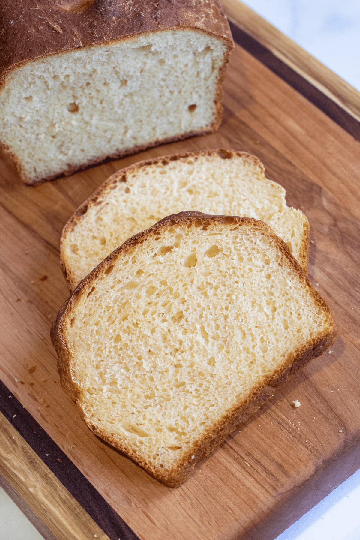 two slices of bread on a cutting board.