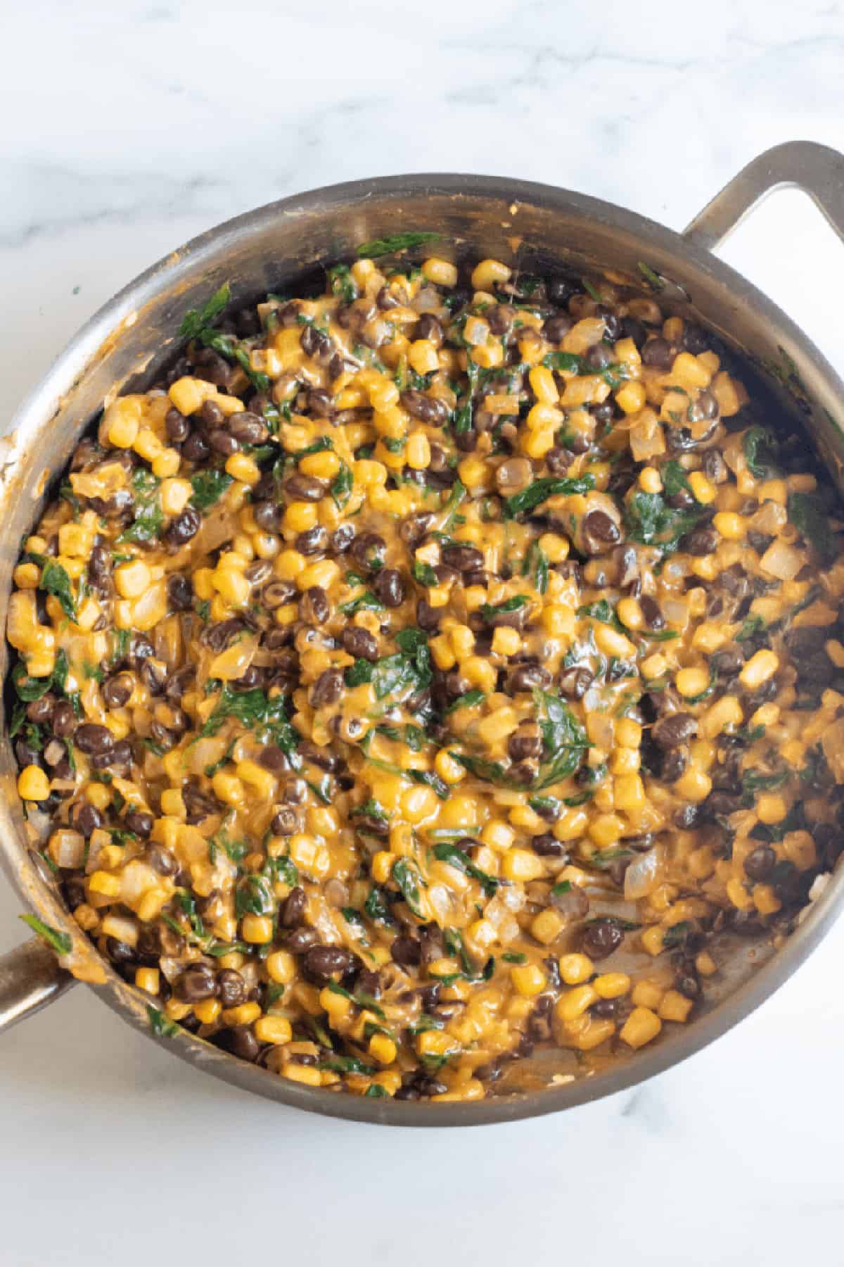a pan with beans, corn, spinach and melted in lots of cheese.