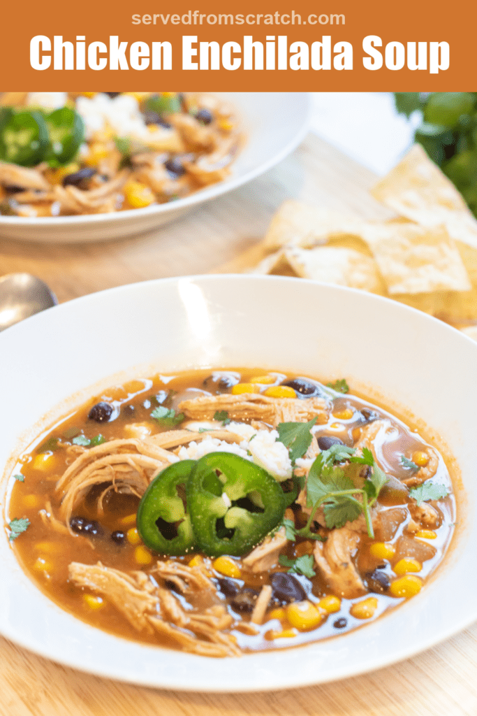 a bowl of chicken enchilada soup with cheese and sliced jalapenos with Pinterest pin text.