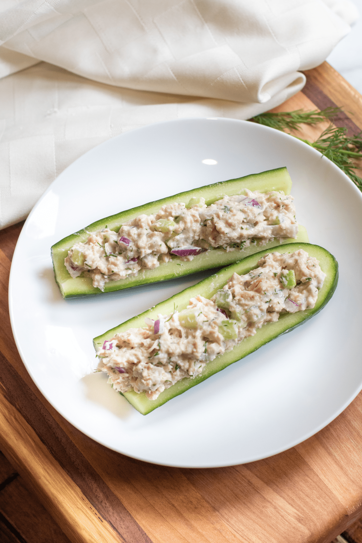 a plate with cucumber boats and tuna salad.