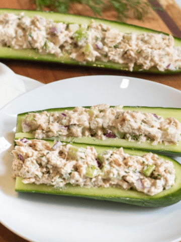 a plate with cucumber boats and tuna salad.