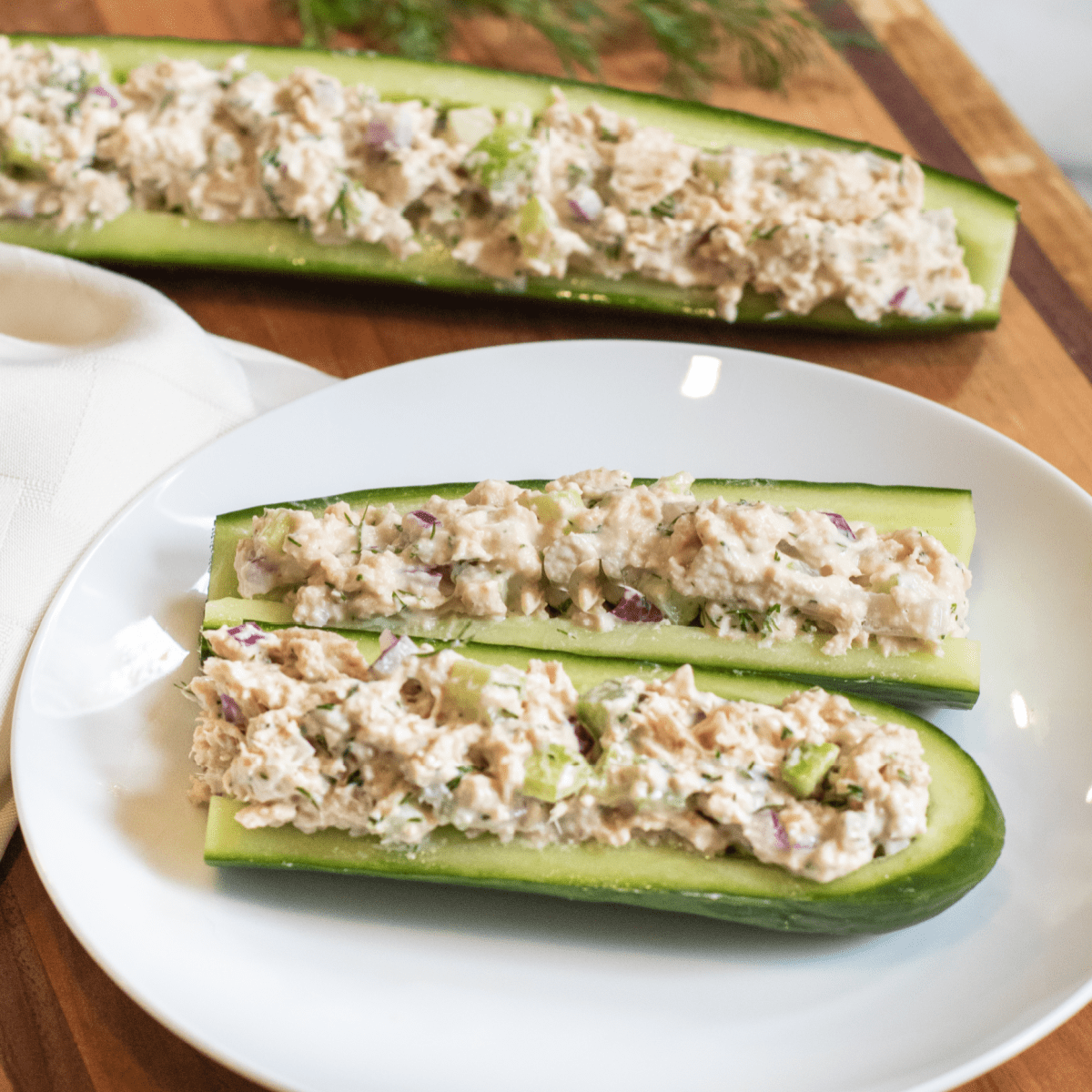 a plate with cucumber boats and tuna salad.