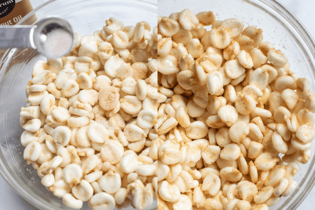 a bowl with a salt mixture being put in and then the bowl of all of the hominy with spices mixed well.