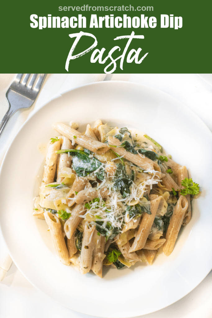 a close up of a bowl of pasta with spinach and artichokes topped with Parmesan cheese with Pinterest pin text.