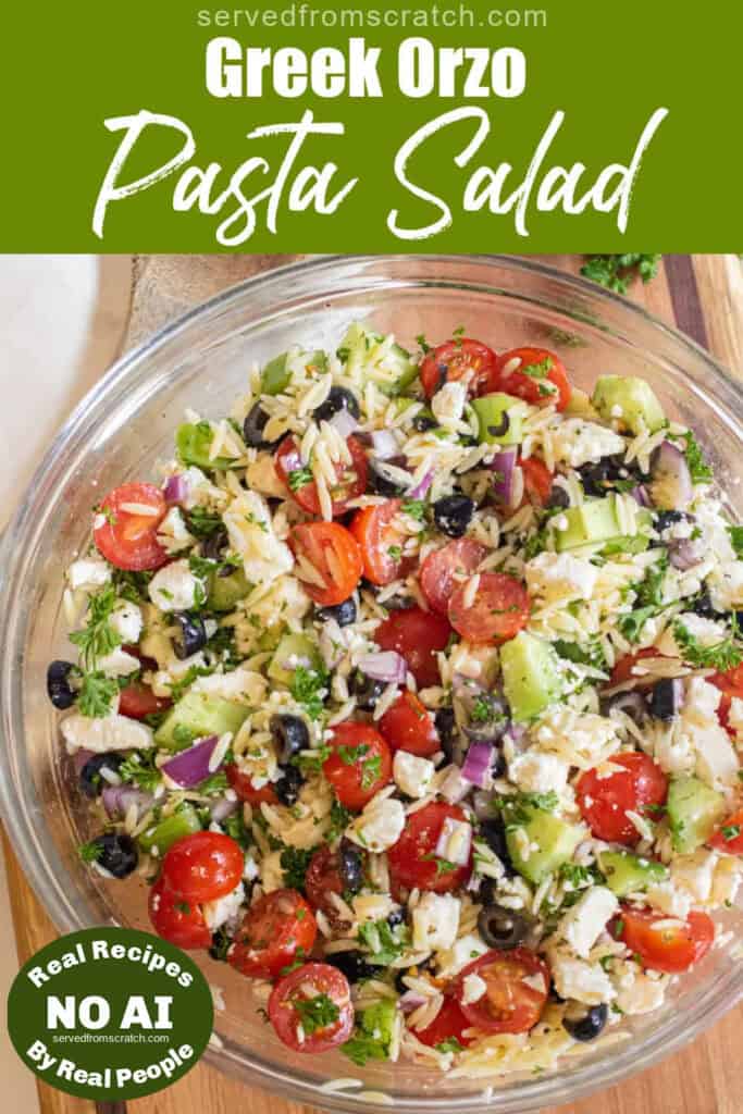 a large bowl of olives, cucumbers, tomatoes, orzo, feta with Pinterest pin text with NO AI sticker.
