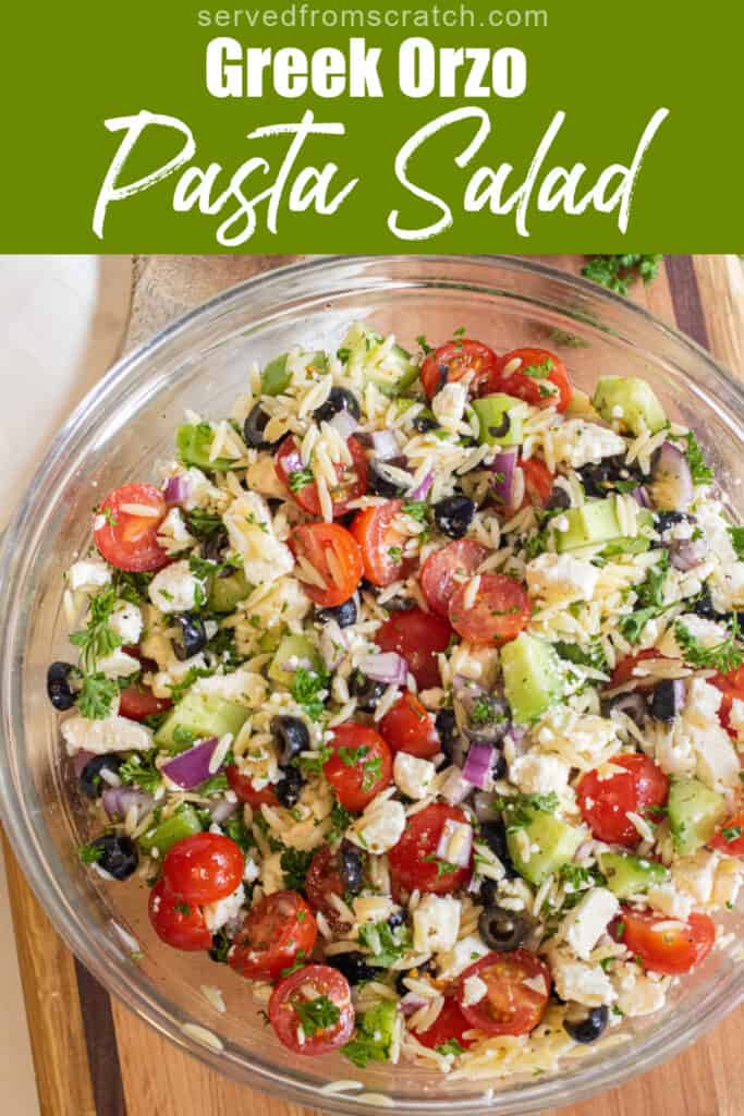 a large bowl of olives, cucumbers, tomatoes, orzo, feta with Pinterest pin text.