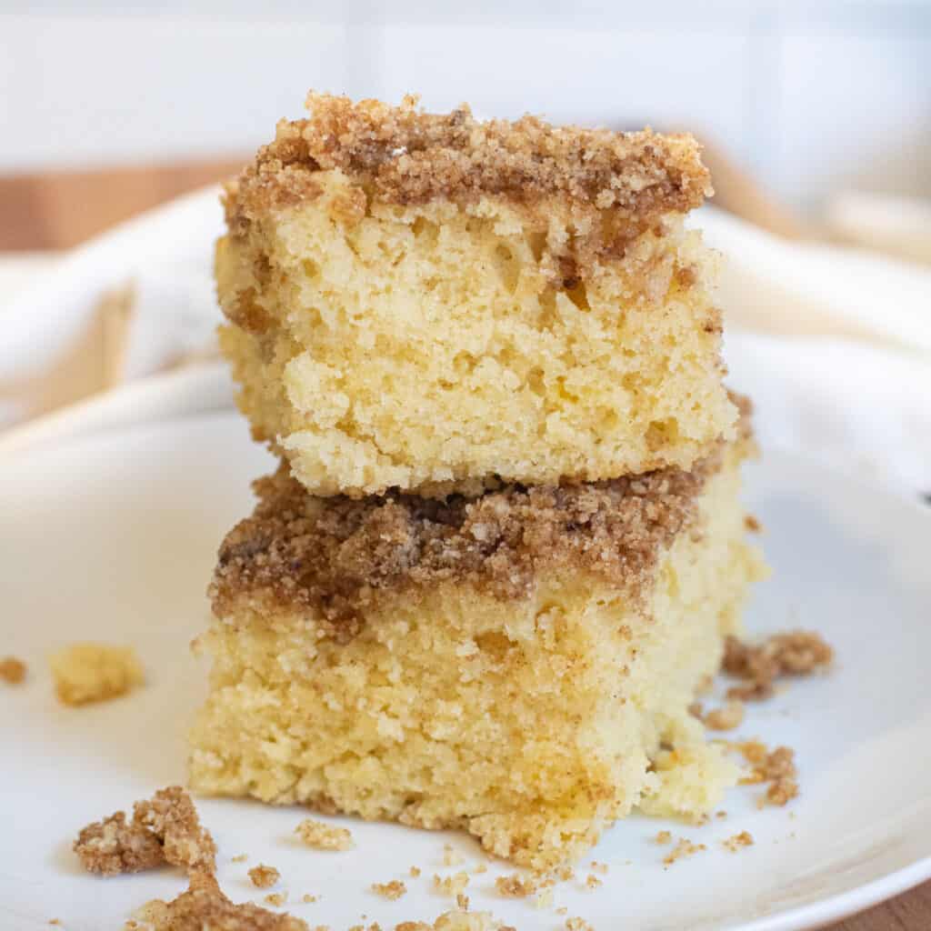 two pieces of coffee cake stacked on a plate.