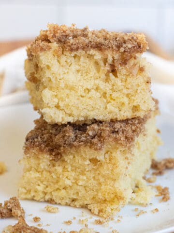 two pieces of coffee cake stacked on a plate.