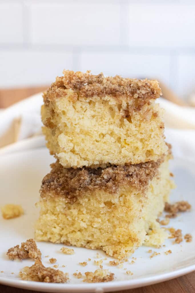 two pieces of coffee cake stacked on a plate.