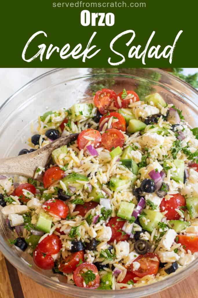 a large bowl of olives, cucumbers, tomatoes, orzo, feta with pinterest pin text.